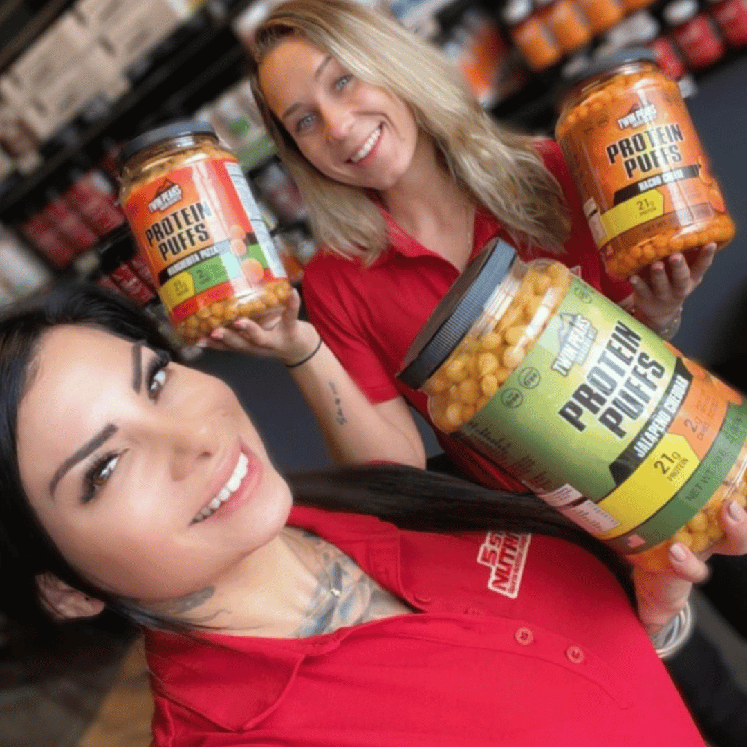 2 Girls Holding 3 Jugs of Protein Puffs